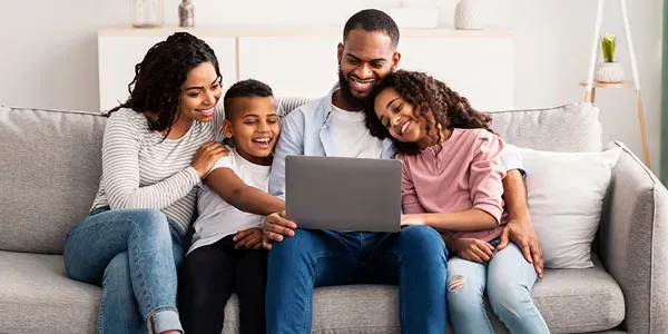 happy family playing on computer in pest free home